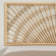 a bed with a wooden headboard made out of bamboo sticks