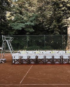 an outdoor table set up with white linens