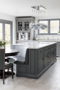 a large kitchen with gray cabinets and white counter tops