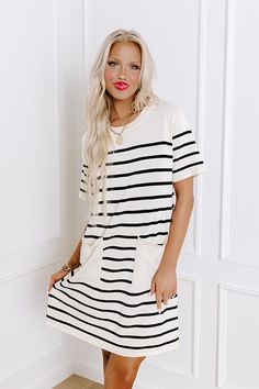 - Step into summer elegance with our chic striped mini dress, the perfect blend of sophistication and playful charm. Effortlessly combining a classic striped pattern with a relaxed silhouette, it is sure to keep you looking country club cute! Add a little bit of class and a little bit of sass to your wardrobe with this must-have piece. - Unlined thigh knit material with a striped pattern - A crew cut neckline - Short sleeves - Functional low pockets - A relaxed silhouette that ends in a straight Summer Elegance, Crew Cut, Crew Cuts, Striped Mini Dress, Knitting Materials, Country Club, Dress Length, Must Haves, Short Sleeves