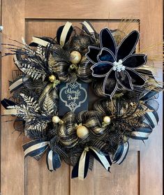 a black and gold wreath on a wooden door