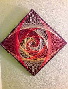 a red and yellow art piece hanging on the wall