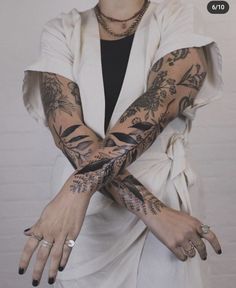 a woman with tattoos on her arms and hands