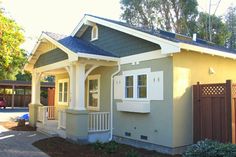 a small house with a blue roof and white trim