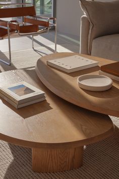 a coffee table with books on it in a living room