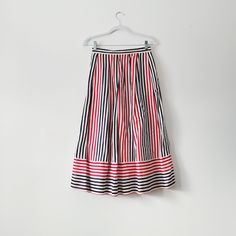 80s red, white, and blue pinstriped pleated midi skirt from brand Breckenridge. One side has a pocket and the other is hook and eye closure. Vertical stripes meet horizontal stripes at the hem.  Lightweight fabric of 70% cotton, 30% linen.  Vintage size 8 - fits like medium 13 inches across the waist,  31.5 inches full length Check out other listings in our shop for more vintage clothing, housewares, and more: Uprightvintagemi.etsy.com *Please read the item description and title, view all photos Summer Workwear Skirt With Vertical Stripes, Spring Striped Midi Skirt, Striped Pleated Skirt For Work, Spring Striped Tiered Skirt, Pleated Striped Skirt For Work, Striped Midi Skirt For Spring, Spring Striped Long Skirt, Casual Striped Pleated Skirt, Striped Long Skirt For Spring