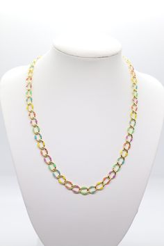 This necklace is a beautiful piece of jewelry that will add a touch of elegance to any outfit. It is made of a small chain that is multi-colored, with each link a different shade of the rainbow. The necklace is adjustable, so you can wear it as a choker or a longer necklace. It is a great addition to any jewelry collection. Multicolor Necklaces With Gold Chain For Gift, Multicolor Long Chain Necklace, Rainbow Chain Necklace As Gift, Rainbow Chain Necklace For Gift, Green Adjustable Chain Link Necklace, Green Chain Link Necklace With Adjustable Chain, Green Necklace With Adjustable Chain, Multicolor Link Jewelry With Adjustable Chain, Multicolor Link Chain Jewelry