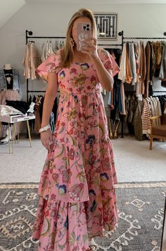 Get ready to bloom in the Blossom Tiered Ruffle Dress! This gorgeous maxi dress features a stunning floral print, combining shades of pink, blue, yellow, green and magenta. With ruffle sleeves, a tiered skirt, and subtle side cut outs, this dress flatters any figure. The elastic waist and back ensure a comfortable fit. Perfect for any occasion, this dress is a must-have in your wardrobe. (P.S. It's true to size - no need to guess!) I'm in a small. Ruffled Tiered Maxi Dress For Brunch, Pink Flowy Tiered Dress With Ruffles, Bohemian Tiered Dress With Ruffles For Garden Party, Flowy Pink Tiered Dress With Ruffles, Spring Floral Print Maxi Dress With Ruffle Sleeves, Spring Tiered Skirt Maxi Dress With Ruffles, Ruffled Tiered Skirt Maxi Dress For Brunch, Pink Floral Print Dress With Ruffle Sleeves, Pink Ruffle Sleeve Dress With Floral Print