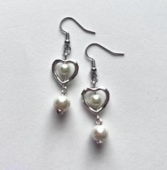 handmade earrings made by beadsadorbs! - made with glass beads, silver charms, acrylic beads and earring hooks made of nickel free metal! message me about customs! all custom requests are welcome! White Heart Bead Dangle Earrings, White Dangle Heart Bead Earrings, White Heart Beads Dangle Earrings, White Dangle Heart Earrings With Beads, Silver Heart-shaped Pearl Earrings, Silver Pearl Heart-shaped Earrings, Silver Heart Earrings With Pearl Drop As Gift, Silver Heart Earrings With Pearl Drop For Gift, White Heart-shaped Pearl Drop Earrings