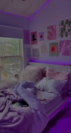 a bed room with a neatly made bed and purple lighting