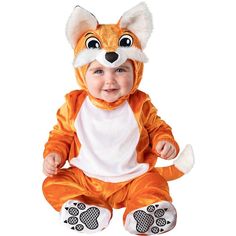 a baby dressed in an orange and white fox costume sitting on the ground with his legs crossed