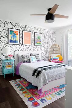 a bedroom decorated in black and white with colorful accents