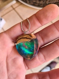 Unique litlle resin dark opal pendant, made of olive wood, resin, and synthetic opal in red/blue/orange color,  Made from the ancient olive wood tree (more than 100 years old). Dried wood. Made in the home craft. Shaped perfectly. Each piece is unique. Comes in a decorative box, ready as a gift. The creation of unique personalized jewelry is the mission. The quality of the performance of each piece of jewelry and the same love and dedication to each of them is the premise. Behind the name "Jewel Artisan Necklace With Natural Inclusions As A Gift, Iridescent Teardrop Necklace For Gifts, Iridescent Opal Necklaces For Gift, Iridescent Opal Necklace For Gift, Iridescent Opal Necklace Perfect For Gifts, Iridescent Teardrop Pendant Necklace For Gift, Handmade Opal Necklaces As Gift, Handmade Opal Necklaces For Gift, Artisan Opal Necklaces As Gifts