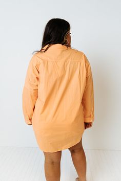 Channel all the good luck on your special day with this casual cute orange plus size top featuring lightweight material, a button up front with a collared neckline, long loose sleeves with roll tab cuffs, a single accent chest pocket, and a relaxed silhouette that falls into a rounded hemline!   Measurements 1XL variant has  a Bust of 58",  a Hip of 54",  a Length of 35",  a Sleeve Length of 15",  a Waist of 53".  2XL variant has  a Bust of 60",  a Hip of 55",  a Length of 36",  a Sleeve Length Orange Long Sleeve Blouse With Relaxed Fit, Oversized Long Sleeve Orange Blouse, Orange Relaxed Fit Long Sleeve Blouse, Oversized Orange Long Sleeve Blouse, Oversized Orange Long Sleeve Top, Long Sleeve Peach Blouse For Fall, Peach Long Sleeve Blouse For Fall, Orange Fall Blouse For Daywear, Fall Orange Blouse For Daywear