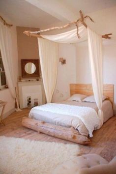 a white bed sitting on top of a wooden floor