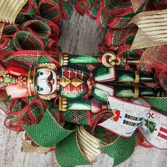 a christmas wreath with holiday decorations on it