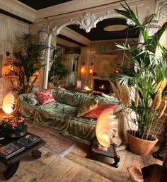 a living room filled with lots of furniture next to a fire place and potted plants