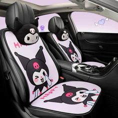 the interior of a car with two cartoon cats on it's seat covers,