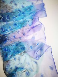 Hand painted luxury Silk Chiffon scarf Cornflowers in Periwinkle sky, Cornflower Blue field and some navy/petrol blue accents. Chiffon is very light and transparent pure silk fabric. It looks so beautiful and mysterious in layered applications. -------------------------------------------------------------------------------------------------------------------------------------------------------------------- This design Scarf is MADE TO ORDER and available in 2 SQUARE and 5 OBLONG sizes: 21*x21 in Elegant Hand Painted Blue Silk Scarf, Elegant Hand Painted Blue Scarves, Elegant Blue Hand Painted Scarves, Artistic Hand Dyed Blue Silk Scarf, Blue Silk Scarves For Spring, Hand Painted Blue Silk Scarf For Summer, Blue Bohemian Hand Painted Silk Scarf, Blue Hand Painted Silk Scarf, Blue Hand Painted Bohemian Silk Scarf