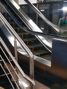 an escalator in a subway station with people on it