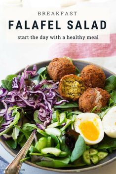 a bowl filled with salad and meatballs on top of it