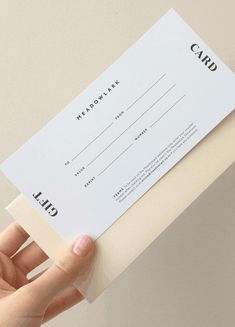 a person holding up a white card with black lettering