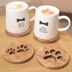 three coffee mugs with dog paw prints on them