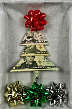 a christmas tree made out of dollar bills with bows on it and money in the background