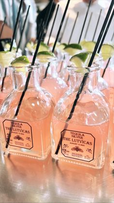 several bottles filled with pink liquid sitting on top of a table next to each other