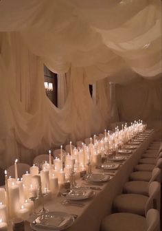 a long table with many white candles on it