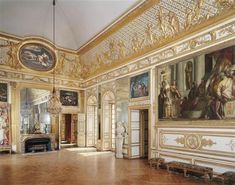 an ornately decorated room with paintings on the walls