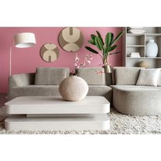 a living room with pink walls and white furniture