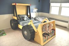 a bed that is made to look like a construction vehicle with bookshelves on it