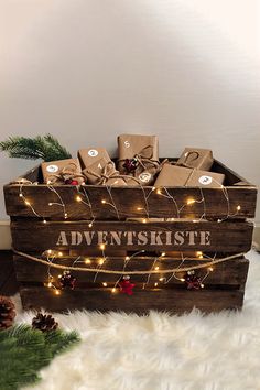 a wooden crate filled with christmas presents on top of a white furnishing floor