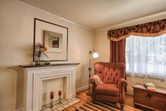 a living room with a chair and fireplace