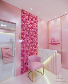 a room with pink walls and flowers on the wall, along with a chair in front of it