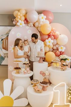 a man and woman standing in front of a cake display