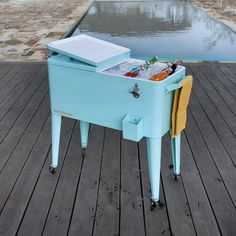 an ice chest sitting on top of a wooden deck