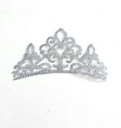 1 x Tiara Crown iron on transfer. For use on COTTON or COTTON MIXED MATERIALS. (Not suitable for low melting point fabrics such as silks or satin)   Please choose from the following sizes - 3'' wide crowns are approximately 7.6cm x 4.6cm  4'' wide crowns are approximately 10.1cm x 6cm 5'' wide crowns are approximately 12.7cm x 7.7cm 6'' wide crowns are approximately 15.2cm wide x 9.2cm  These patches are made from a high quality glitter material, glitter will not shed or flake. Very easy to apply with a household iron or heat press - only 15 seconds required!  Simply place the motif on the garment then iron over design for 10 - 15 seconds, remove iron and wait 5 seconds then peel off plastic and you're done! Full instructions will be provided. Crown Iron, Queen Of Hearts Gold Crown, Customised Princess Crown Iron On Patch, Fancy Costumes, Fabric Glitter, Melting Point, Tiara Crown, Queen Crown, Appliqué Patch