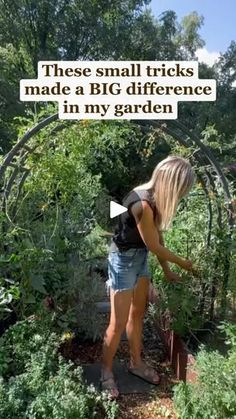 a woman standing in the middle of a garden