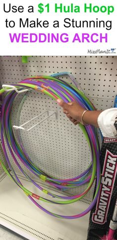 a person holding up a bunch of neon colored hula hoops in a store