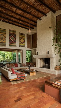 a living room filled with furniture and a fire place in the middle of a room