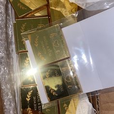 some gold bars are laying on top of each other in a box with white envelopes