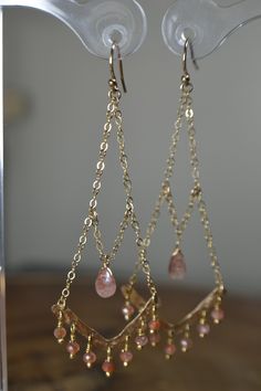 "These Oregon Sunstone Chandelier Earrings display hand formed components against Beautiful and Sparkly Sunstone beads. The featured gemstone reveals beautiful golden speckling in smooth rondelles and a focal Oregon Sunstone Briolette. Earrings are displayed in 14k Gold Fill; they are also available in 14k Rose Gold Fill and Sterling Silver. Personally, I recommend the Gold as the metal accents the Sunstone nicely. These Earrings add a touch of drama to your \"Everyday\" but will carry you into Fusion Style Drop Earrings With Dangling Beads, Fusion Style Dangling Beads Chandelier Earrings For Gift, Handmade Artisan Dangle Chandelier Earrings, Bohemian Wire Wrapped Long Drop Jewelry, Artisan Dangle Chandelier Earrings, Handmade Fusion Chandelier Drop Earrings, Artisan Handmade Dangle Chandelier Earrings, Handmade Fusion Style Chandelier Drop Earrings, Bohemian Long Drop Wire Wrapped Jewelry