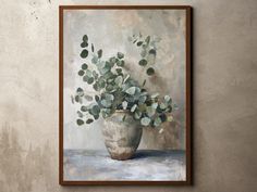 a painting on a wall with a vase full of flowers in front of the frame