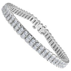 Adorn your wrist with a timeless and captivating piece of jewelry that radiates sophistication and elegance. This exquisite tennis bracelet is a true symbol of luxury, showcasing adjacent pairs of round diamonds with a combined weight of 4 carats. At the heart of this bracelet are the diamonds themselves. Their scintillating brilliance and sheer beauty are a celebration of life's precious moments. The adjacent pairs create a continuous shimmer along your wrist, casting a mesmerizing glow with ev Diamond Bracelet Design, Bracelet Tennis, Antique Bracelets, Diamond Tennis Bracelet, Diamond Jewelry Designs, Square Diamond, Earrings Studs, Tennis Bracelet Diamond, Bezel Diamond