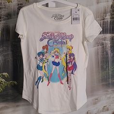 New With Tags! Sailor Moon Crystal Guardians Sparkly Lettering Girls Medium Graphic T-Shirt. Crafted From Lightweight Jersey Fabric, This Short-Sleeve T-Shirt Offers All-Day Comfortable Wear. Designed In A Cream Hue, This Crewneck Tee Features A Graphic Of The Sailor Moon Crystal Guardians Season Three Poster Featuring Sailor Moon And The Other Guardians For A Fan-Favorite Look. Cotton And Polyester Blend. Bundle With Some Of My Other Girls Items To Save More And Pay Only One Shipping! Multicolor Kawaii Tops With Letter Print, Kawaii Cotton Tops With Character Print, Trendy Cotton Tops With Anime Print, Kawaii Cotton Shirt With Character Print, Cotton Anime Print Crew Neck Top, Anime Print Cotton Crew Neck Top, Cotton Anime Print Short Sleeve Top, Multicolor Cotton Anime Print Tops, Short Sleeve Cotton Top With Anime Print