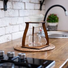 a wooden stand with two glasses on it