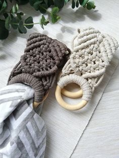 two crocheted cloths are laying next to each other on a white surface