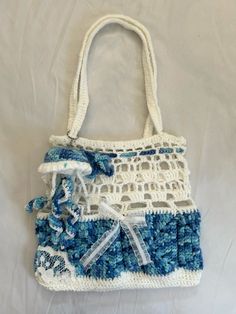 a crocheted purse with blue and white trim